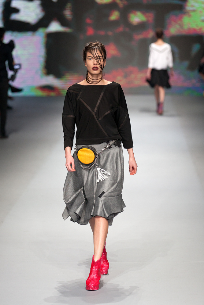 Woman walks the catwalk with a fanny pack