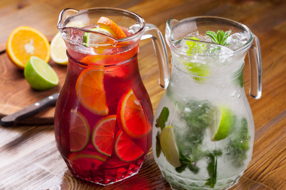 Two jugs of sangria on a wooden tables