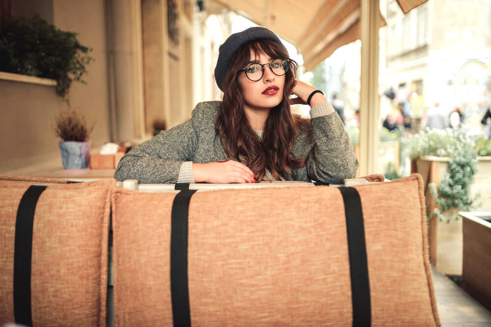 Pretty young woman with red lipstick, glasses, and a beret