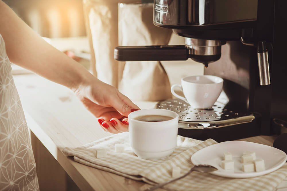 Woman's hands making coffee