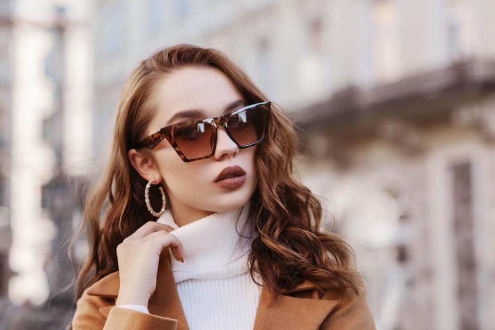 Woman with sunglasses and hoop earrings
