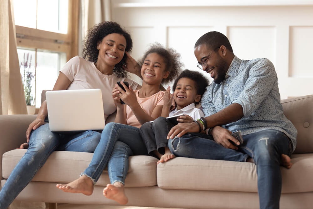Family laughing at laptop