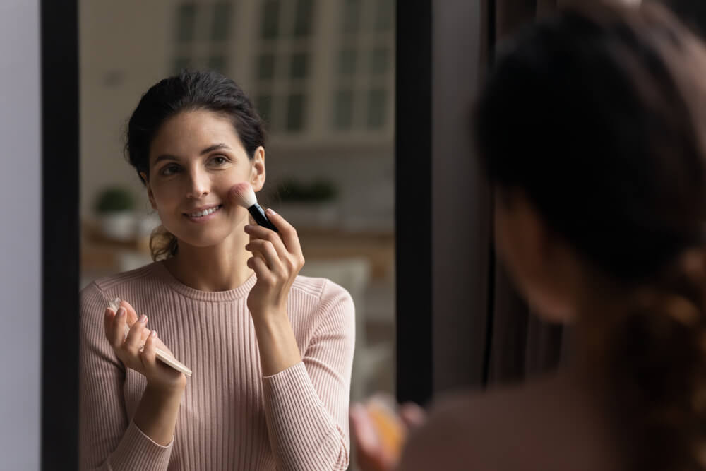 woman applying makeup