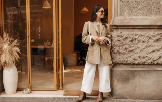 Woman with quiet luxury vibe standing in front of building