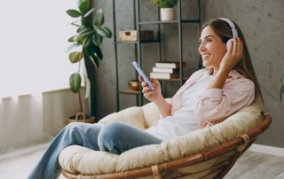 Woman listening to minimalist podcast in her minimalist home