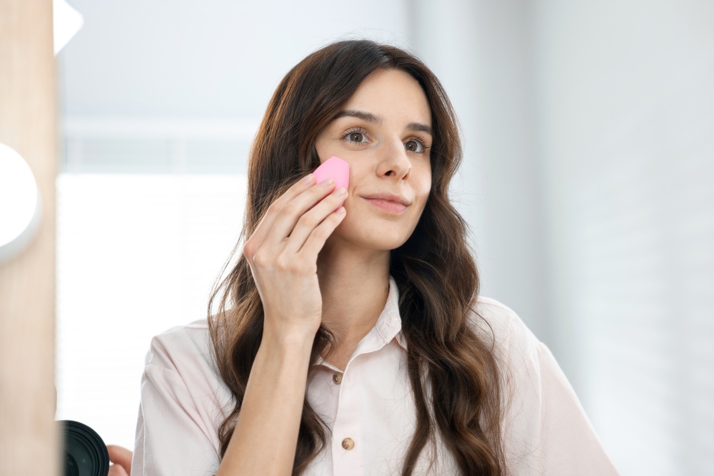 Woman blending makeup and wondering if it looks patchy