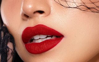 Woman with red lips inspired by award show beauty trends