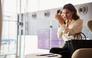 Frequent flyer woman checking skin at airport